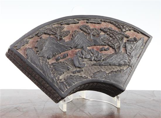 A Chinese black and cinnabar lacquer fan shaped box and cover, 19th century, 25cm, some damage